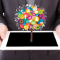 businessman holding tablet with colorful icons 85x85
